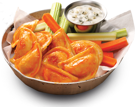 Pierogies in a bowl with carrots, celery, and buffalo sauce